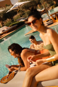 MARPH-OASIS-POOL-SUNBED-SWIMMING-THREE-WOMAN-PALMTREES-CARDS-SUN-BLUE-SKY
